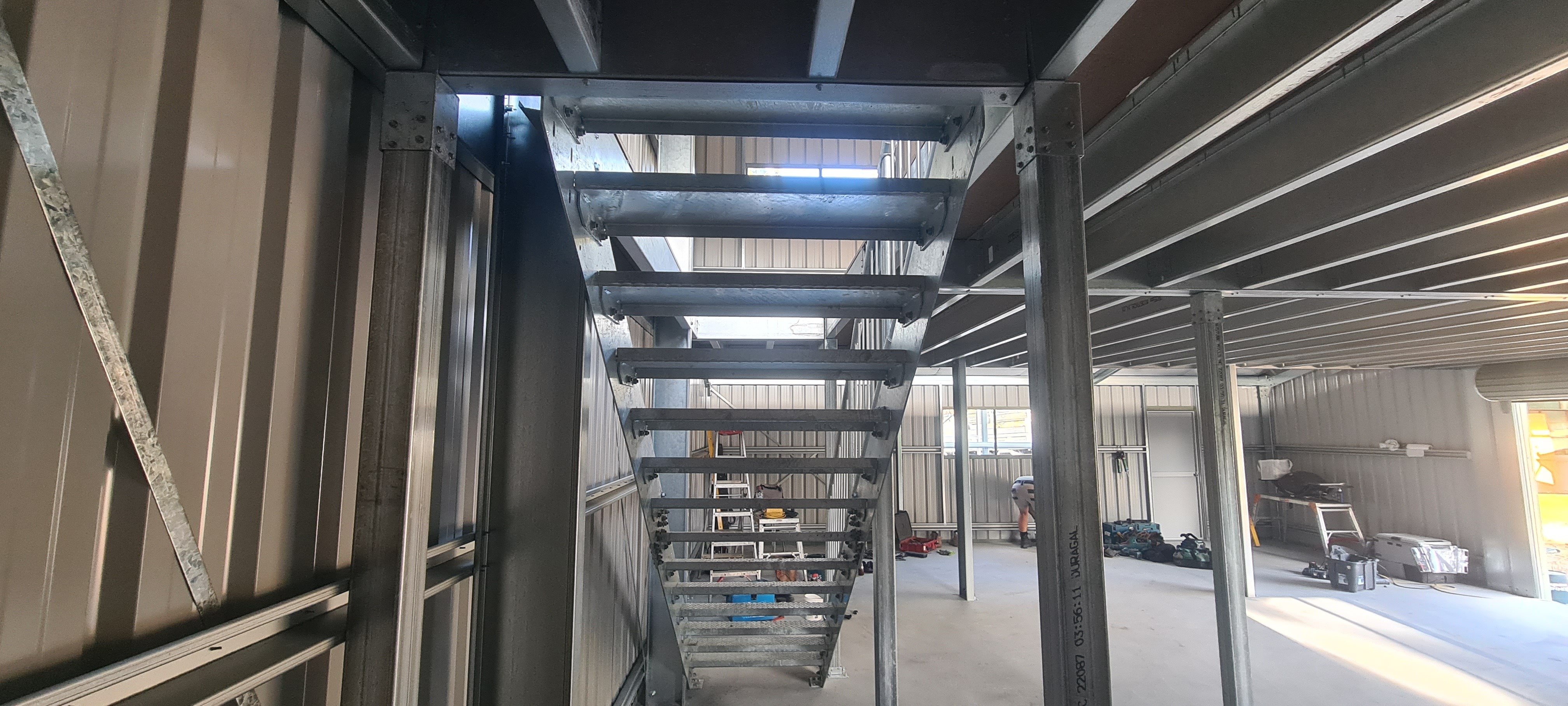 Organised shed interior in Hobart including stairs to maximise storage
