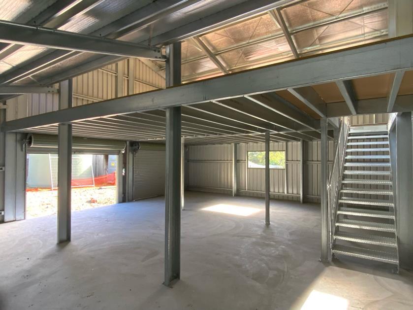 Shed interior with mezzanine floor and stairs in Hobart backyard